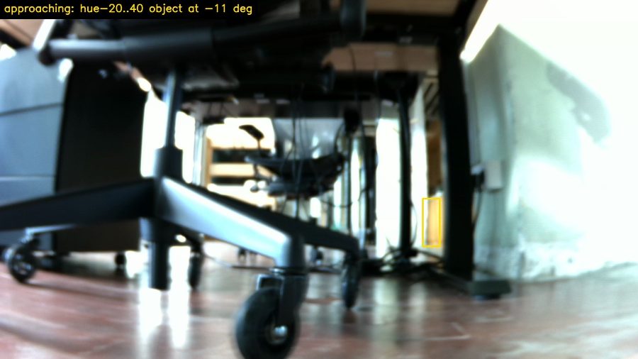 Robot camera frame with burned-in caption 'approaching' and a yellow detection box on the wrong object